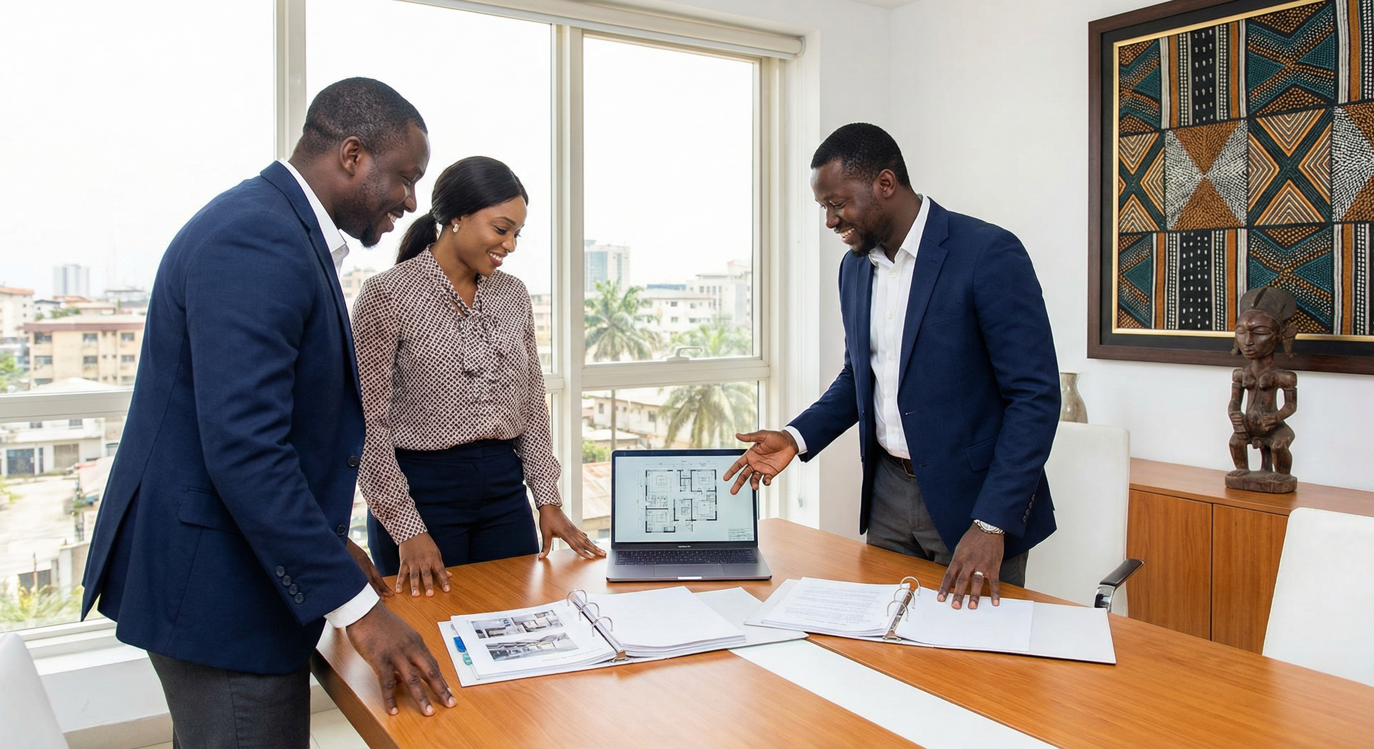 Nigerian professional real estate agents collaborating in a modern office